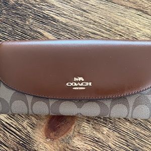 Coach brown signature saddle flap continental wallet.